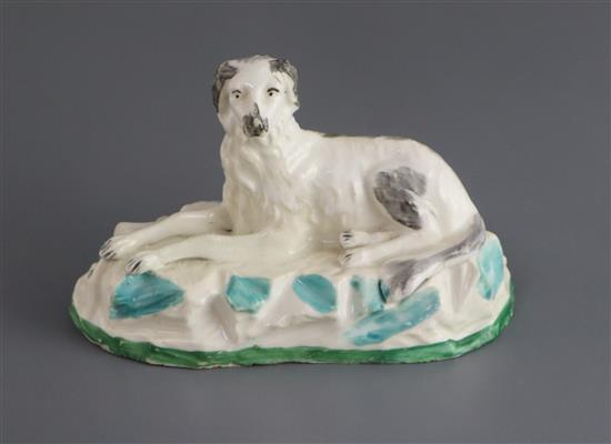 A Madeley porcelain figure of a recumbent Saluki, c.1830, L. 12.7cm